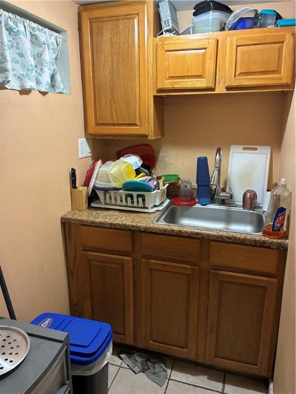 121 Murray St, Providence, RI 02909 - kitchen featuring light tile patterned floors and brown cabinetry