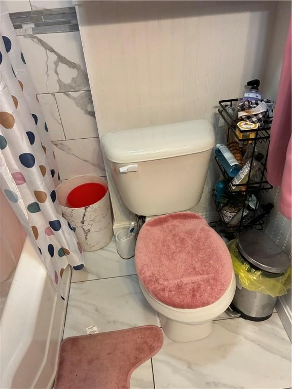 121 Murray St, Providence, RI 02909 - bathroom with marble look tile flooring and shower / bath combo with shower curtain