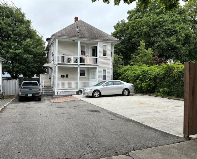 121 Murray St, Providence, RI 02909 - view of front facade with a balcony, covered porch, and a chimney
