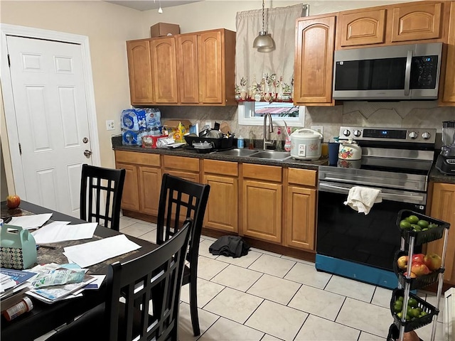 121 Murray St, Providence, RI 02909 - kitchen with stainless steel appliances, dark countertops, tasteful backsplash, and brown cabinetry