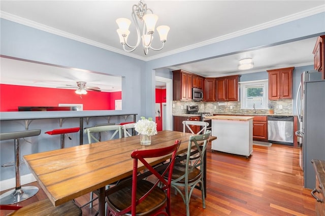 4 Linwood St, West Warwick, RI 02893 - dining area with wood finished floors, a chandelier, ornamental molding, and ceiling fan