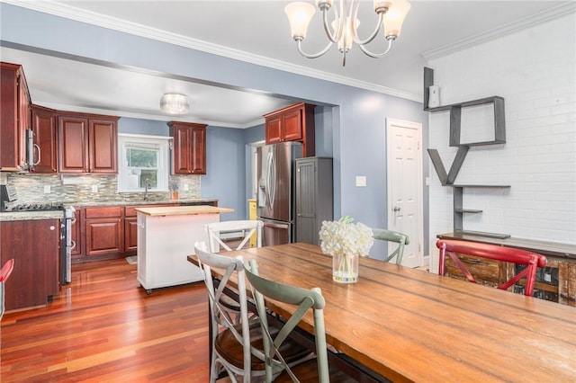 4 Linwood St, West Warwick, RI 02893 - dining room featuring dark wood-style flooring, a chandelier, and ornamental molding