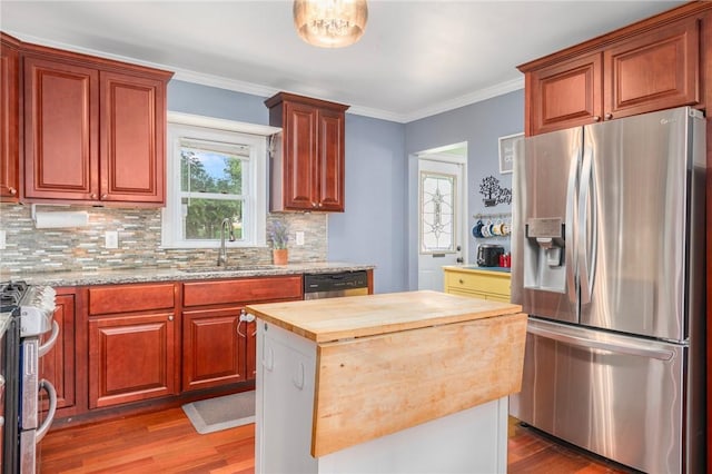 4 Linwood St, West Warwick, RI 02893 - kitchen featuring appliances with stainless steel finishes, wood finished floors, butcher block counters, backsplash, and crown molding