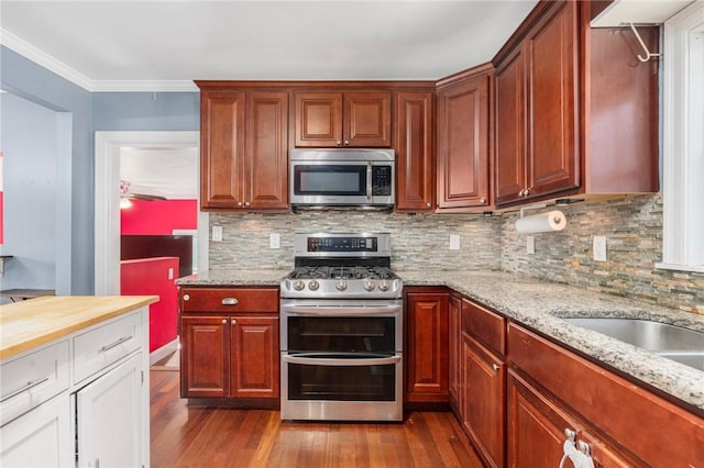 4 Linwood St, West Warwick, RI 02893 - kitchen with appliances with stainless steel finishes, dark wood-style floors, backsplash, ornamental molding, and light stone counters