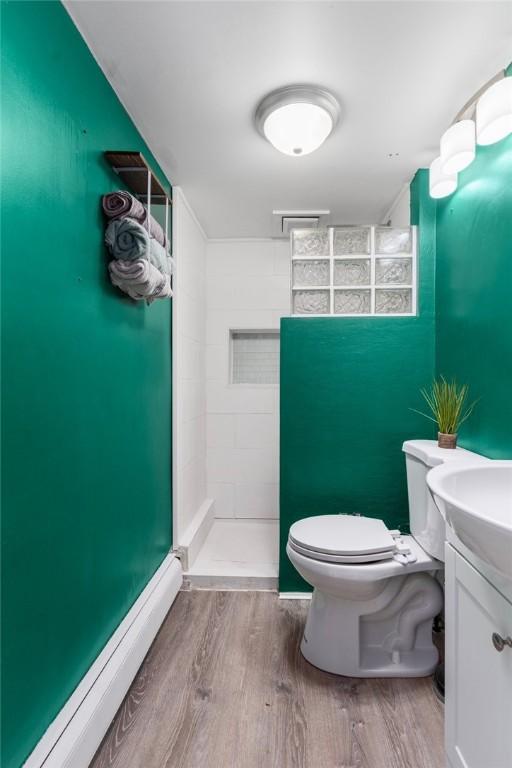 4 Linwood St, West Warwick, RI 02893 - bathroom featuring wood finished floors, a tile shower, and vanity