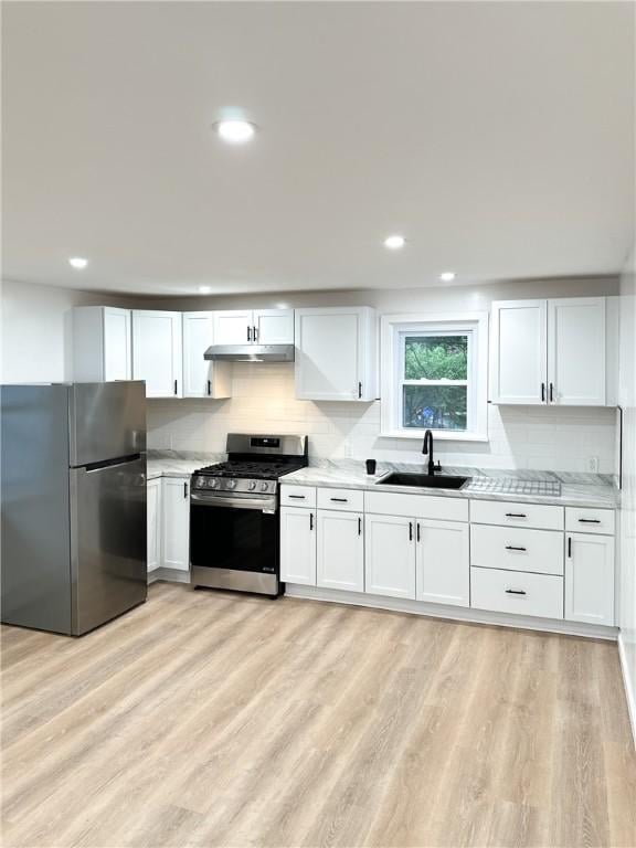 9 Octavia St, Providence, RI 02909 - kitchen with stainless steel appliances, under cabinet range hood, white cabinets, decorative backsplash, and recessed lighting