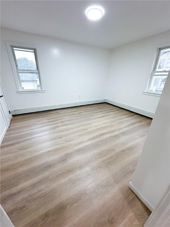 9 Octavia St, Providence, RI 02909 - spare room with healthy amount of natural light, baseboard heating, and wood finished floors