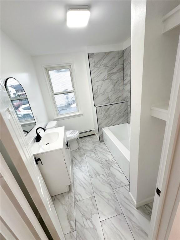 9 Octavia St, Providence, RI 02909 - bathroom featuring marble look tile flooring, vanity, a baseboard radiator, and  shower combination