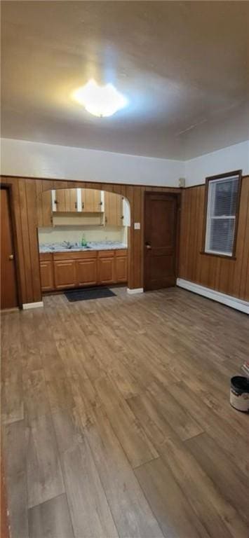 9 Octavia St, Providence, RI 02909 - kitchen with brown cabinets, wood finished floors, and a baseboard radiator