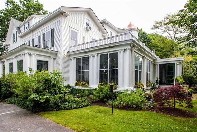 446 Bellevue Ave Unit 6, Newport, RI 02840 - view of side of property with a sunroom, a chimney, and a lawn