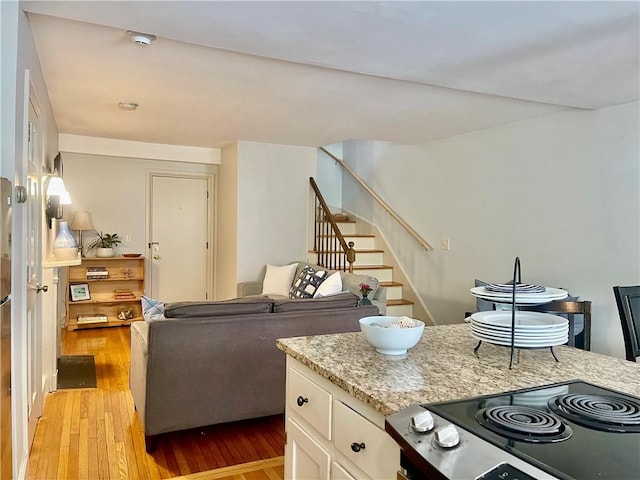 446 Bellevue Ave Unit 6, Newport, RI 02840 - kitchen featuring light wood-style flooring, white cabinets, and light stone countertops