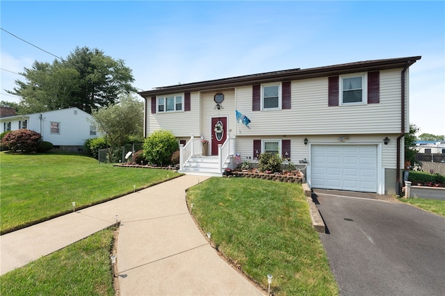 17 Cedar Dr, West Warwick, RI 02893 - bi-level home with an attached garage, driveway, and a front lawn