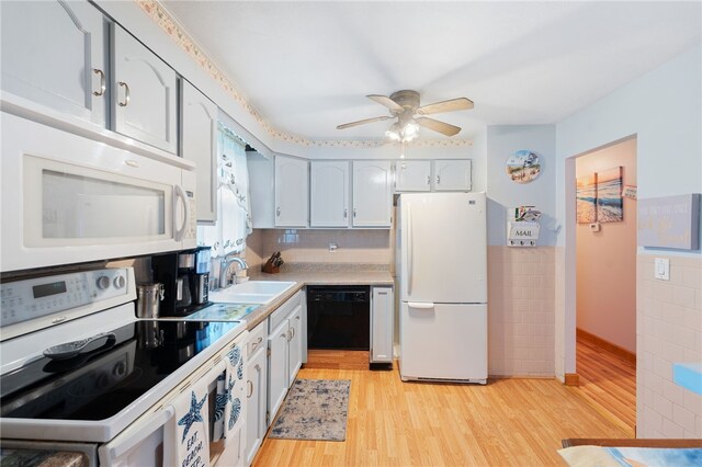 17 Cedar Dr, West Warwick, RI 02893 - kitchen featuring white appliances, light wood finished floors, ceiling fan, light countertops, and a wainscoted wall