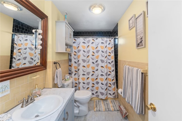 17 Cedar Dr, West Warwick, RI 02893 - bathroom with tile walls, vanity, and shower / bathtub combination with curtain