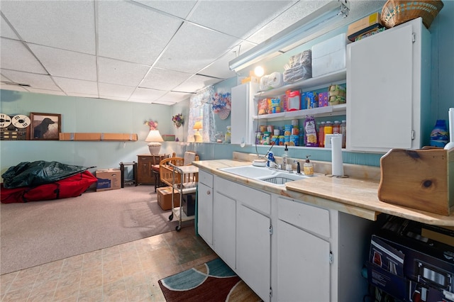 17 Cedar Dr, West Warwick, RI 02893 - interior space with a paneled ceiling, light countertops, white cabinets, carpet floors, and open shelves