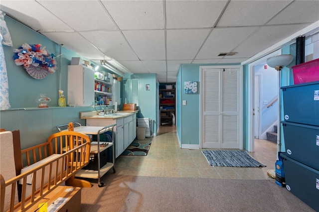 17 Cedar Dr, West Warwick, RI 02893 - kitchen with a drop ceiling, open shelves, and light colored carpet
