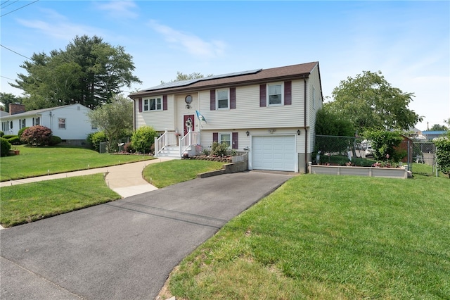 17 Cedar Dr, West Warwick, RI 02893 - raised ranch featuring roof mounted solar panels, a garage, and asphalt driveway