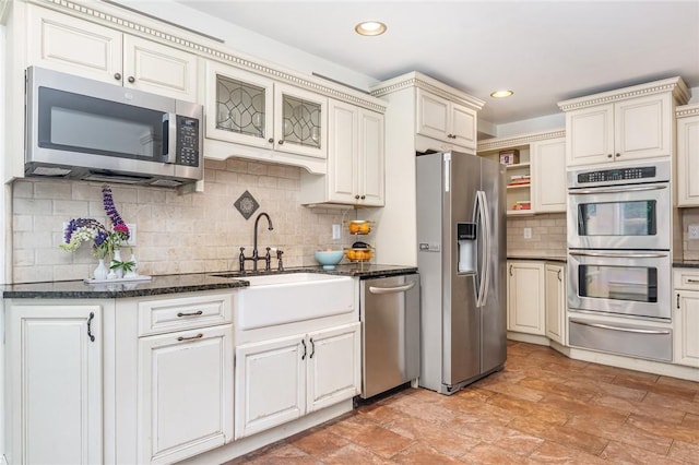 214 Highland Rd, Tiverton, RI 02878 - kitchen with appliances with stainless steel finishes, a warming drawer, tasteful backsplash, dark stone countertops, and recessed lighting