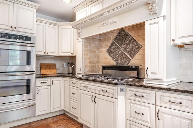 214 Highland Rd, Tiverton, RI 02878 - kitchen featuring appliances with stainless steel finishes, a warming drawer, decorative backsplash, dark stone counters, and white cabinets