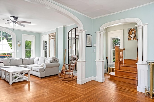 214 Highland Rd, Tiverton, RI 02878 - living area featuring decorative columns, arched walkways, healthy amount of natural light, a ceiling fan, and crown molding