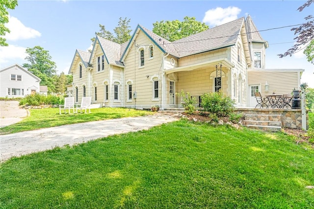 214 Highland Rd, Tiverton, RI 02878 - victorian home with a porch, a front yard, and roof with shingles