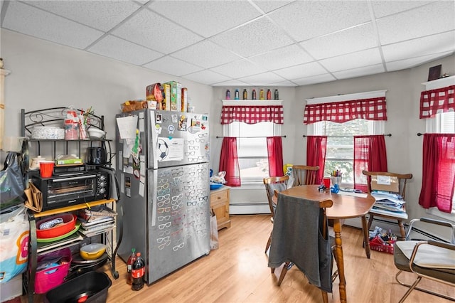 233 Waterman Ave, East Providence, RI 02914 - kitchen featuring freestanding refrigerator, a paneled ceiling, wood finished floors, and a baseboard radiator