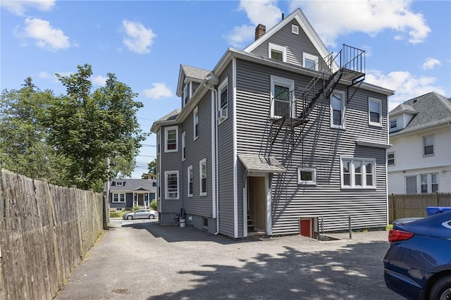 233 Waterman Ave, East Providence, RI 02914 - view of property exterior with a chimney