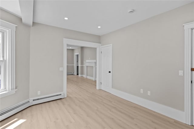 233 Waterman Ave, East Providence, RI 02914 - empty room featuring a baseboard radiator, light wood-style floors, a smoke detector, baseboard heating, and recessed lighting