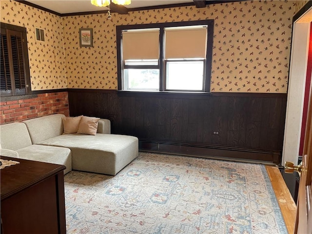 37 Kermit St, Woonsocket, RI 02895 - living area with a wainscoted wall, a baseboard radiator, wallpapered walls, and ornamental molding