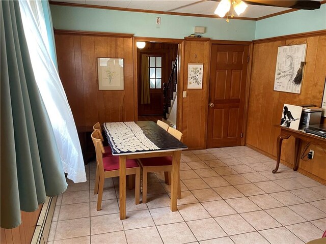 37 Kermit St, Woonsocket, RI 02895 - dining space featuring a ceiling fan, light tile patterned floors, wooden walls, stairs, and ornamental molding