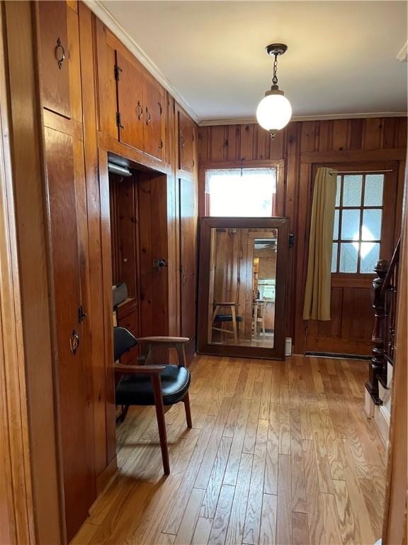 37 Kermit St, Woonsocket, RI 02895 - entryway featuring light wood-type flooring, healthy amount of natural light, wood walls, and ornamental molding