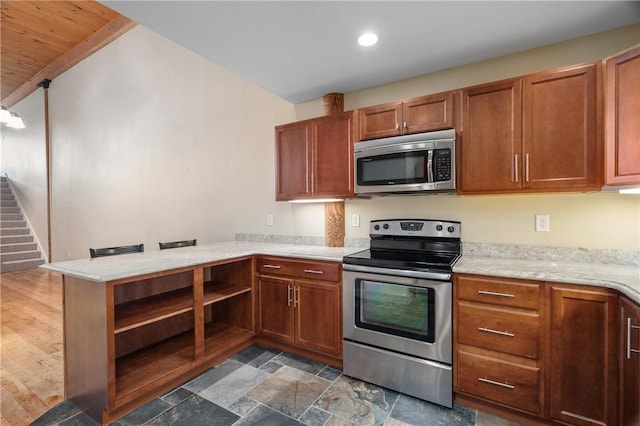 1 Tupperware Dr Unit 231, North Smithfield, RI 02896 - kitchen with stainless steel appliances, open shelves, a peninsula, brown cabinetry, and recessed lighting