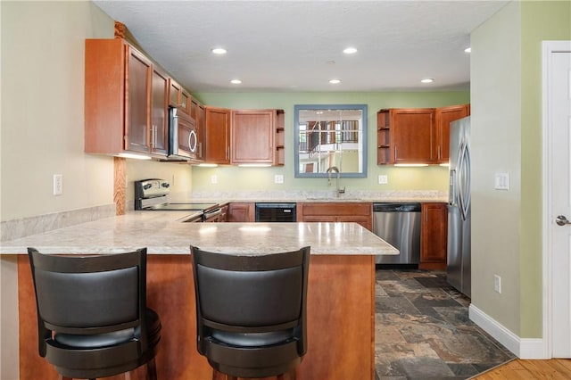 1 Tupperware Dr Unit 231, North Smithfield, RI 02896 - kitchen with appliances with stainless steel finishes, a peninsula, open shelves, recessed lighting, and dark stone finish floors