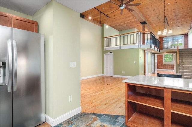 1 Tupperware Dr Unit 231, North Smithfield, RI 02896 - kitchen with stainless steel refrigerator with ice dispenser, a ceiling fan, a wooden ceiling with exposed beams, decorative light fixtures, and brown cabinets
