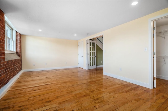 1 Tupperware Dr Unit 231, North Smithfield, RI 02896 - spare room featuring light wood-style floors, recessed lighting, and brick wall