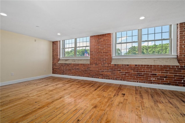 1 Tupperware Dr Unit 231, North Smithfield, RI 02896 - spare room with light wood-type flooring, healthy amount of natural light, brick wall, and recessed lighting