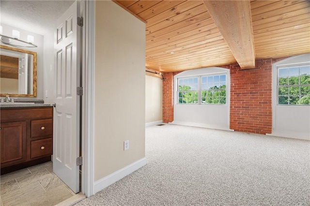1 Tupperware Dr Unit 231, North Smithfield, RI 02896 - empty room featuring a wood ceiling with exposed beams, light carpet, and brick wall