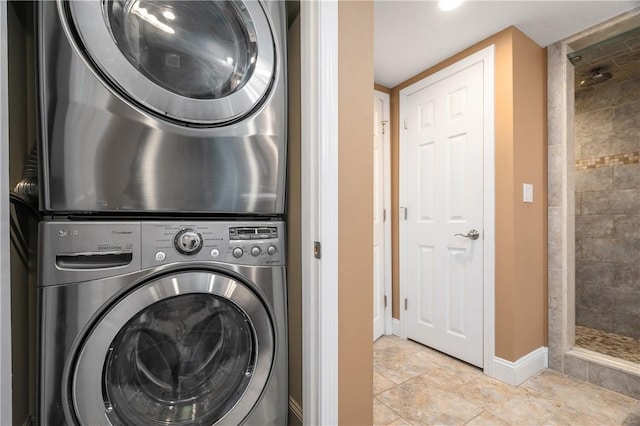 1 Tupperware Dr Unit 231, North Smithfield, RI 02896 - laundry room featuring stacked washer / dryer and baseboards