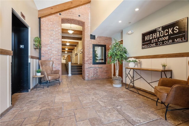 1 Tupperware Dr Unit 231, North Smithfield, RI 02896 - lobby with beam ceiling, stairway, and brick wall