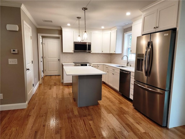 3 Sutcliffe Ave, Lincoln, RI 02865 - kitchen featuring stainless steel appliances, light countertops, ornamental molding, tasteful backsplash, and a kitchen island