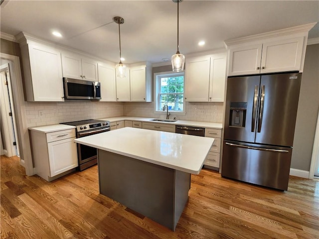3 Sutcliffe Ave, Lincoln, RI 02865 - kitchen with stainless steel appliances, light countertops, white cabinets, wood finished floors, and recessed lighting