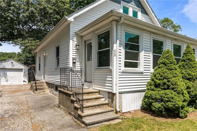 35 Inman Ave, Warwick, RI 02886 - view of front of house featuring an outdoor structure, asphalt driveway, and a garage
