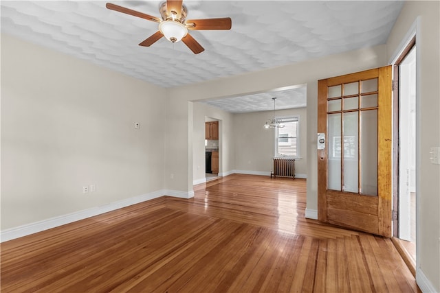 35 Inman Ave, Warwick, RI 02886 - entryway with radiator, light wood-style flooring, a chandelier, and a ceiling fan