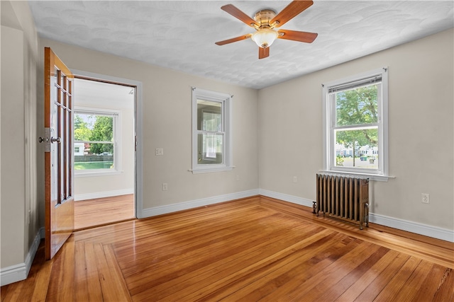 35 Inman Ave, Warwick, RI 02886 - unfurnished room with radiator heating unit, wood-type flooring, and a ceiling fan