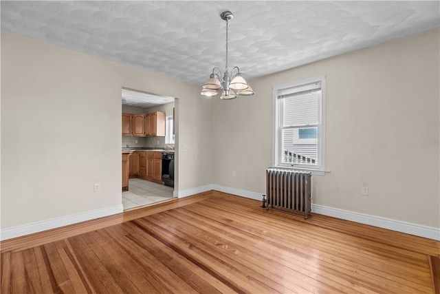 35 Inman Ave, Warwick, RI 02886 - unfurnished room with radiator heating unit, a chandelier, and light wood-type flooring
