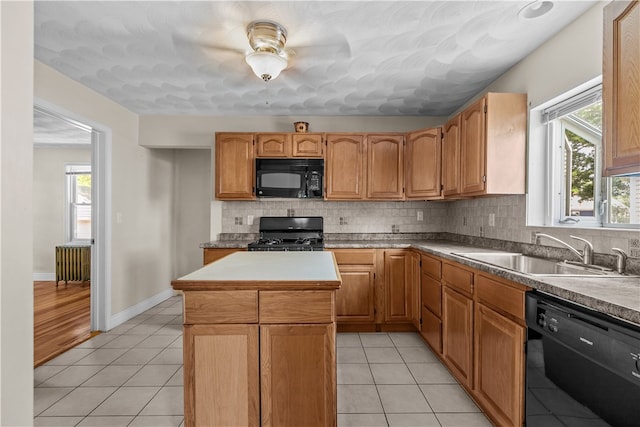 35 Inman Ave, Warwick, RI 02886 - kitchen featuring black appliances, radiator heating unit, healthy amount of natural light, and a center island