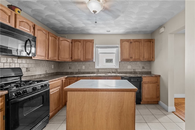 35 Inman Ave, Warwick, RI 02886 - kitchen with black appliances, light tile patterned flooring, tasteful backsplash, a kitchen island, and brown cabinets