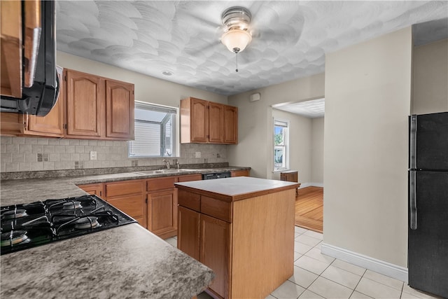 35 Inman Ave, Warwick, RI 02886 - kitchen with black appliances, tasteful backsplash, light tile patterned floors, a kitchen island, and ceiling fan