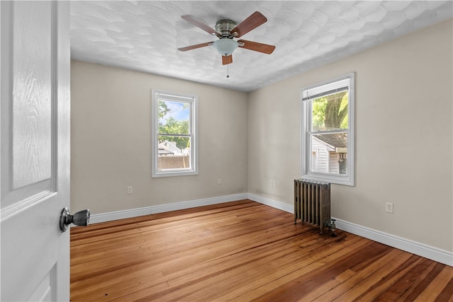 35 Inman Ave, Warwick, RI 02886 - empty room with radiator, hardwood / wood-style flooring, and ceiling fan
