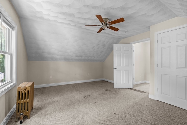 35 Inman Ave, Warwick, RI 02886 - additional living space featuring radiator heating unit, vaulted ceiling, ceiling fan, healthy amount of natural light, and carpet flooring